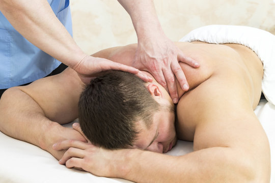 Man doing sports massage at the massage parlor 