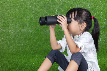Asian Chinese little girl looking through binoculars