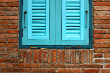 blue window on the brick wall
