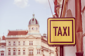 Taxi sign on the street in Prague. Tourism and travel concept. Toned selective focus image