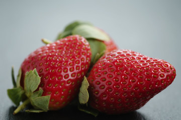 ripe organic strawberries on slate background, closeup