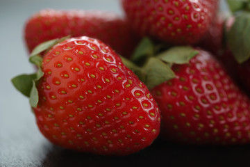 ripe organic strawberries on slate background, closeup