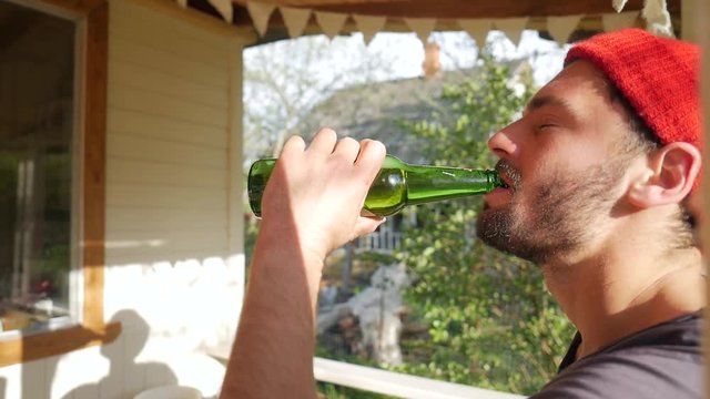 Young Caucasian Hipster Man Drinking Beer at Picnic. HD Slowmotion Lifestyle Footage.