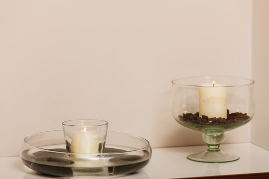 Decorative candles in bowls with coffee seeds