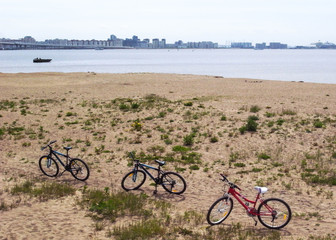 Fototapeta premium Relax on the beach. Cyclists lie on the sand.
