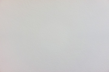The white wall surface is rough in soft light.