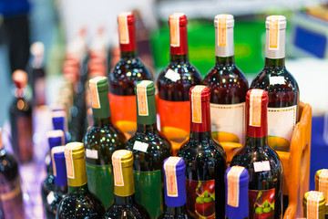 Many wine bottles are placed in the Alcohol Sales Zone in the supermarket.