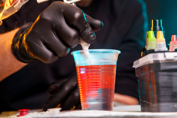 master tattoo artist prepares tools for tattooing