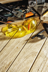 Safety glasses and tools on the workbench