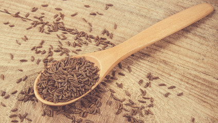 Cumin in a spoon . Close Up .