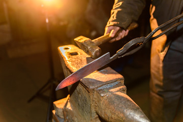 Forging molten metal. Making knives.