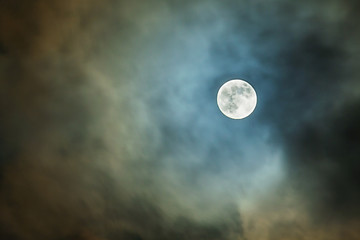 Naklejka na ściany i meble The full moon in the night sky through the clouds