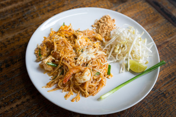 Thai Fried Noodles in white dish on wooden table