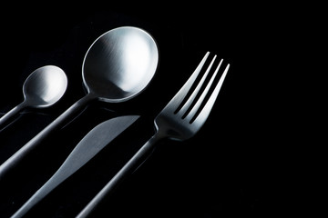 black fork, knife and spoon