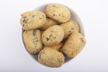 a handful of homemade croquettes of spinach isolated on white