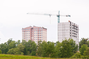 Construction of new house or building. General view. Unfinished cement building in the summer. The introduction of urbanization into nature. Capital construction in Ukraine