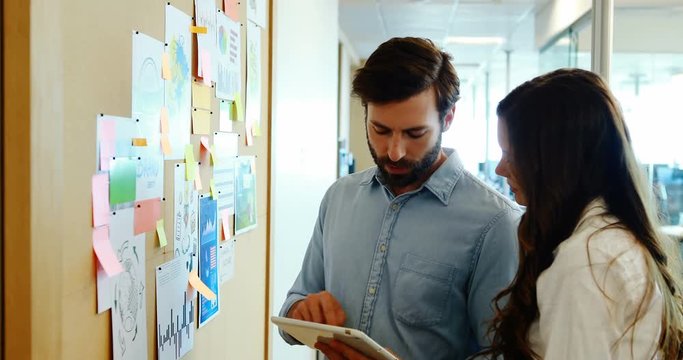 Business colleagues discussing over sticky notes
