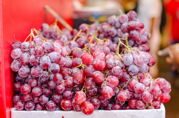 Bunch of raw grape display at fresh market.