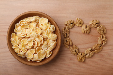 Corn flakes in bowl and walnuts