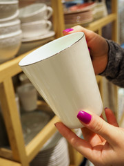 woman choosing new crockery in dinnerware store