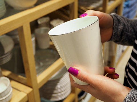 Woman Choosing New Crockery In Dinnerware Store