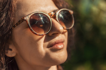 the woman's portrait close up in sunglasses