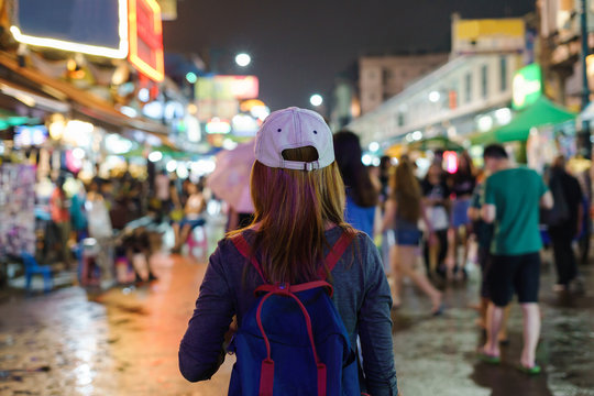 Young Woman Traveler Walking In The Khao San Road At Night