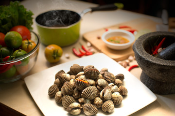 Fresh Cockles in the dish with Vegetables and ingredient prepare for seafood sauce Scald cockles / Selective focus and Still Life food image.