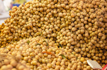 Fresh longan fruit on market stall in Malaysia.