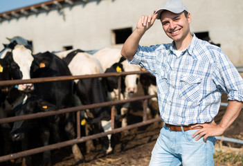 Breeder in front of his cows