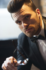 Handsome man portrait with bow tie and tuxedo suit