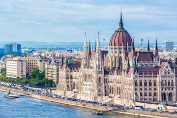 Naklejka na ściany i meble Travel and european tourism concept. Parliament and riverside in Budapest Hungary with sightseeing ships during summer day with blue sky and clouds