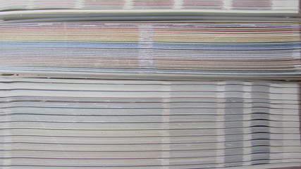 a stack of colored paper, folded cardboard