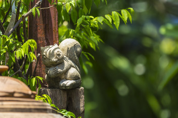 Obraz premium Squirrel stucco doll in the garden with green bokeh background.