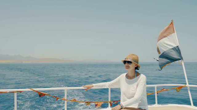 Woman enjoying a trip on yacht sitting on deck, Egypt