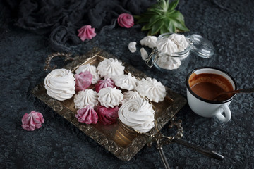 vanilla and raspberry homemade zephyr and cacao mug on dark stone background. sweet delicious marshmallows,  selective focus