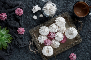 vanilla and raspberry homemade zephyr and cacao mug on dark stone background. sweet delicious marshmallows, top view