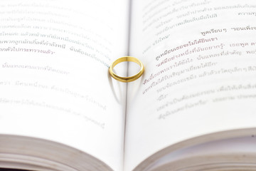 Wedding gold ring a on the book.