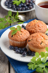 Homemade  blueberry muffins on rustic wooden background, selective focus