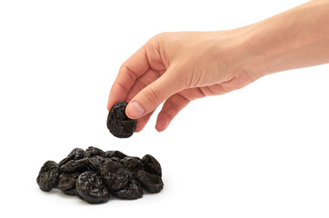 female hand holds dry prunes. isolated on white background