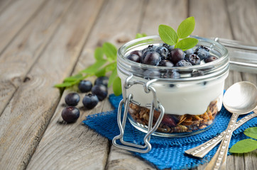 Yogurt parfait with granola and fresh blueberries, healthy breakfast concept, selective focus, copy space