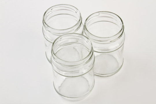Transparent household containers, white background. Several glass jars isolated.