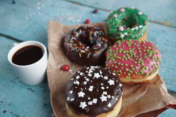 delicious homemade donuts on  rustic turquoise  wooden background. Delicious breakfast, selective focus
