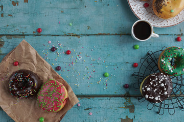 delicious homemade donuts on  rustic turquoise  wooden background. Delicious breakfast, top view, selective focus