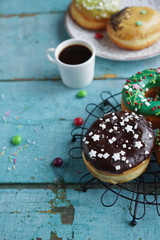 delicious homemade donuts on  rustic turquoise  wooden background. Delicious breakfast, selective focus