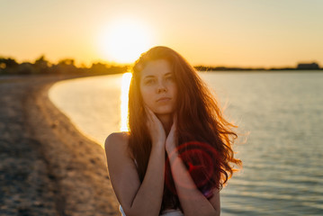 Portrait of a woman with long hair at sunset close-up