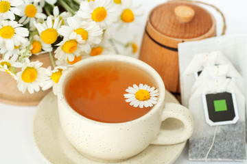 cup of herbal chamomile tea with camomile dry blossoms, dried camomile flowers. doctor treatment and prevention of immune concept, medicine - folk, alternative, complementary, traditional medicine