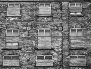 large old brick building with boarded up windows