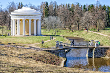 Fototapeta na wymiar The Temple of Friendship and The Cast Iron bridge in the Pavlovsk park.