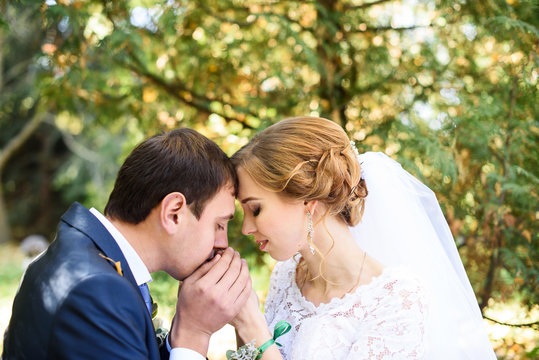 Bride and groom in a park kissing. couple newlyweds bride and groom at a wedding in nature green forest are kissing photo. Wedding Couple